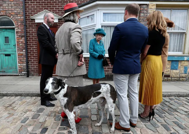 Britain's Queen Elizabeth II meets actors and members of the production team as she visits the set of the long running television series Coronation Street in Manchester, northwest England on July 8, 2021. (Photo by Scott Heppell/Pool via AFP Photo)
