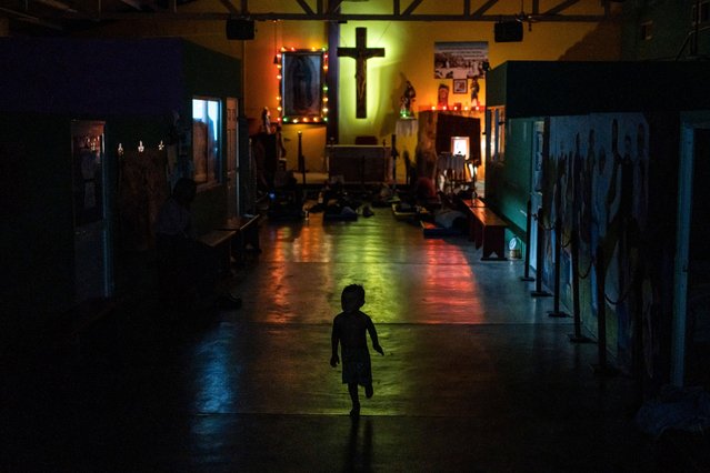 A young migrant runs through the Peace Oasis of the Holy Spirit Amparito shelter where migrants sleep on the floor on mats in Villahermosa, Mexico, late Friday, June 7, 2024. After the head of Mexico's immigration agency ordered a halt to deportations in December, migrants have been left in limbo as authorities round up migrants across the country and dump them in the southern Mexican cities of Villahermosa and Tapachula. (Photo by Felix Marquez/AP Photo)