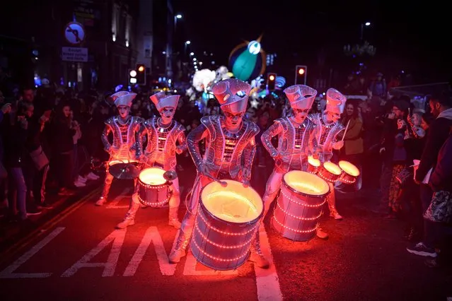 Performers with “Spark!”, an LED-illuminated theatrical drumming ensemble, entertain the public during the annual “Light Night Leeds” festival of visual arts in the centre of Leeds, northern England on October 10, 2019. Celebrating the diverse and thriving creativity of Leeds, Light Night Leeds is an annual free multi-arts and light festival that takes over Leeds City Centre for two nights in October. (Photo by Oli Scarff/AFP Photo)