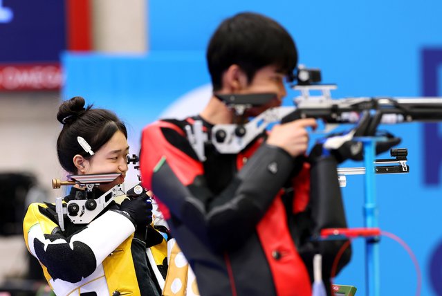 China’s Huang Yuting, left, competes in the 10-meter air rifle mixed-team shooting competition with Sheng Lihao on July 27, 2024. They won the first gold medal of the Paris Olympics. (Photo by Charles McQuillan/Getty Images)
