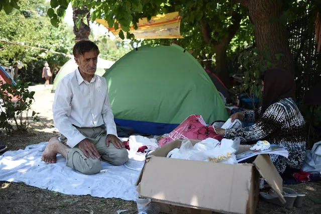 An Afghan refugee prays in the Pedion tou Areos park in central Athens, on Friday, July 24, 2015. (Photo by Giannis Papanikos/AP Photo)