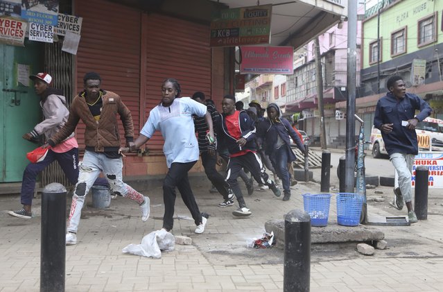 Protestors run during a demonstration rally against hunger in Nairobi, Kenya, Thursday August 8, 2024. (Photo by Andrew Kasuku/AP Photo)