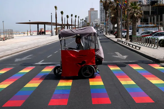 People cross a rainbow-coloured pedestrian crossing before the gay pride parade in Tel Aviv, Israel, June 3, 2016. (Photo by Baz Ratner/Reuters)