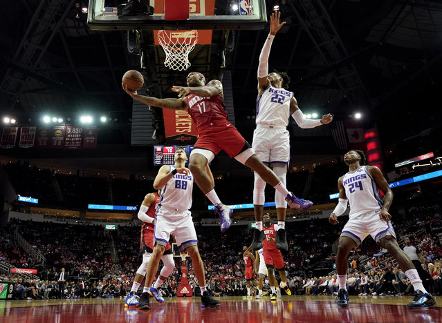 Houston Rockets' PJ Tucker (17) goes up for a shot as Sacramento Kings' Nemanja Bjelica (88), Richaun Holmes (22) and Buddy Hield (24) defend during the first half of an NBA basketball game Monday, December 9, 2019, in Houston. (Photo by David J. Phillip/AP Photo)