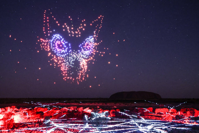 A scene from the global launch of Wintjiri Wiru depicting an evil spirit shape shifting into Kurpany, the devil dog on May 10, 2023 in Uluru, Australia. “Wintjiri Wiru” is an Aboriginal cultural storytelling experience brought to life through state-of-the-art technology with more than 1,100 drones, laser and light projections over the Central Australian desert. Acknowledgement – Anangu share the Mala story, from Kaltukatjara to Uluru, through a drone, sound and light show designed and produced by RAMUS. (Photo by David Gray/Getty Images for Voyages Indigenous Tourism Australia)