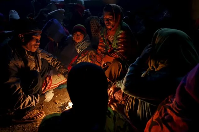 Hindu worshippers gather around a fire keep themselves warm as they wait for the Kasada Festival ceremony to commence at Mount Bromo in Probolinggo, Indonesia's East Java province, August 1, 2015. (Photo by Reuters/Beawiharta)