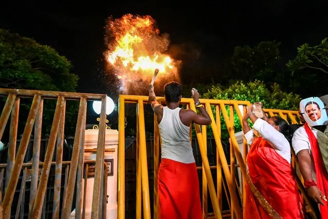 Activists stage a mock ritual to exorcise demons outside the official residence of Sri Lanka's Prime Minister Mahinda Rajapaksa while demanding the resignations of Mahinda and President Gotabaya Rajapaksa over the country's crippling economic crisis, in Colombo on May 8, 2022. (Photo by Ishara S. Kodikara/AFP Photo)