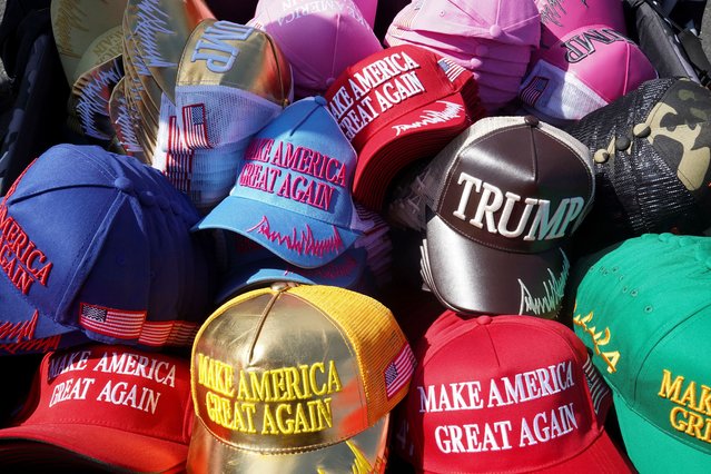 A pile of hats showing support for Republican presidential nominee former President Donald Trump are displayed ahead of a campaign stop called Believers and Ballots Faith Town Hall at Christ Chapel in Zebulon, Georgia on October 23, 2024. (Photo by Megan Varner/Reuters)