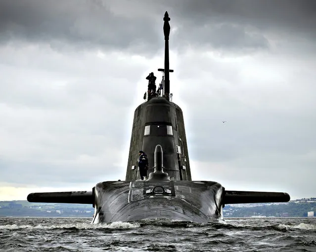 A handout made available by the Britsh Ministry of Defence showing HMS Artful, the third of the British Royal Navy s new Astute Class attack submarines on arrival at her Scottish base port of HMNB Clyde, Faslane, Scotland, 19 August 2015 from where she will carry out sea trials before entering service later this year. The 7,400-tonne Artful left BAE Systems construction yard at Barrow-in-Furness in Cumbria several days ago before sailing to her new home at Her Majesty s Naval Base (HMNB) Clyde. (Photo by Thomas McDonald/EPA)