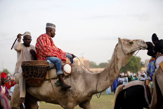 Palace guards ride on a camel during the durbar festival on the second day of Eid-al-Fitr celebrations in Nigeria's northern city of Kano, July 7, 2016. (Photo by Akintunde Akinleye/Reuters)