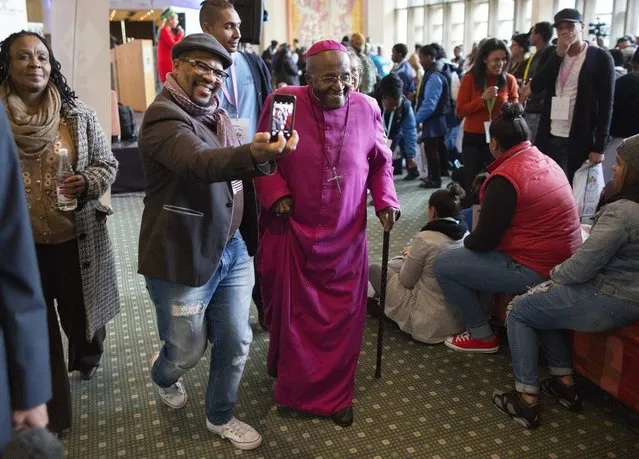 Nobel peace laureate Archbishop Emeritus Desmond Tutu (C) gets a selfie with a fan as he departs the Youth Health Festival on Youth Day in Cape Town, South Africa 16 June 2016. The 40th anniversary of Youth Day commemorates the 1976 Soweto student uprisings during the apartheid era. Youths attending the festival learned about their rights and freedoms and the choices and consequences related to sexual practices and health. (Photo by Nic Bothma/EPA)