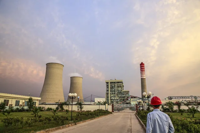 A Chinese worker walks along a path at the Sahiwal coal power plant, owned by China's state-owned Huaneng Shandong Rui Group, in Sahiwal, Punjab, Pakistan, on Wednesday, June 14, 2017. Pakistan is racing to bridge its power supply gap before national elections next year after a series of widespread blackouts highlighted the fragility of the network and its negative pull on South Asias second largest economy. (Photo by Asad Zaidi/Bloomberg via Getty Images)