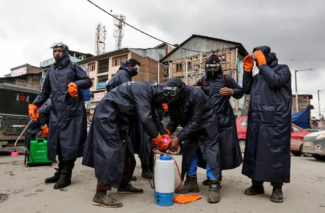 Municipal workers prepare to disinfect a mosque, amid coronavirus disease (COVID-19) fears, in Srinagar on March 13, 2020. (Photo by Danish Ismail/Reuters)