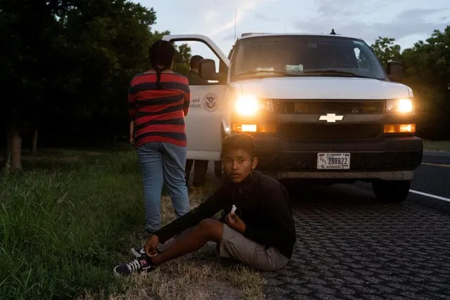 Asylum seeking migrant minors from Honduras are picked up by an U.S. Customs and Border Protection agent,, after crossing the Rio Grande river into the U.S. from Mexico, at Eagle Pass, Texas, U.S., July 25, 2022. (Photo by Go Nakamura/Reuters)