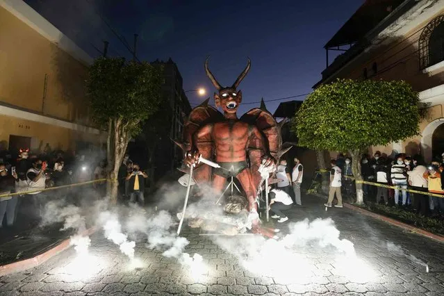 An effigy representing the Devil is set to burn during the Virgin of the Immaculate Conception celebrations in Guatemala City, Tuesday, December 7, 2021. (Photo by Moises Castillo/AP Photo)