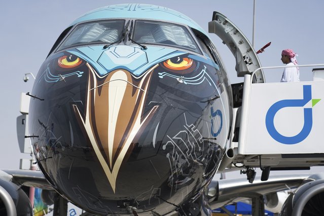 An man boards an Embraer E195-E2 jet nicknamed the “Profit Hunter” at the Dubai Air Show in Dubai, United Arab Emirates, Thursday, November 16, 2023. (Photo by Jon Gambrell/AP Photo)