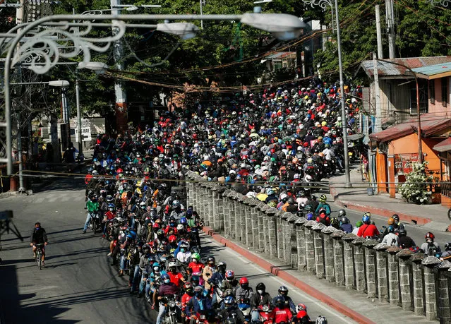 Motorcycle riders crowd a military checkpoint in Las Pinas city, Metro Manila, Philippines, 20 April 2020. According to reports, Philippine President Rodrigo Duterte has threatened a martial law-like crackdown in case the number of quarantine violators continues to rise. Police said more than 100,000 individuals have violated the quarantine protocols – caught outside their homes without valid reasons. (Photo by Francis R. Malasig/EPA/EFE/Rex Features/Shutterstock)