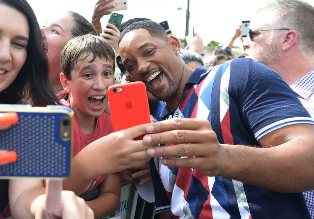 Actor Will Smith takes a selfie with fans at the “Suicide Squad” Wynwood Block Party and Mural Reveal on July 25, 2016 in Miami, Florida. (Photo by Gustavo Caballero/Getty Images for Warner Bros. Pictures)