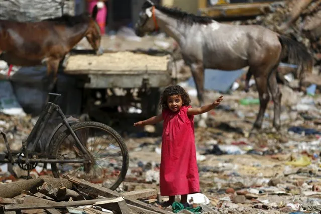 A girl plays in the Eshash el-Sudan slum in the Dokki neighbourhood of Giza, south of Cairo, Egypt September 2, 2015. (Photo by Amr Abdallah Dalsh/Reuters)