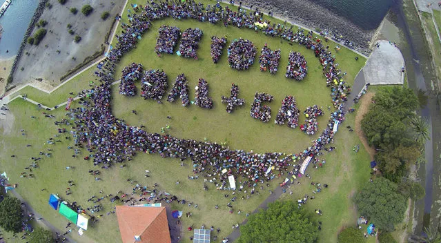 In this handout picture taken from a drone, enviromental protesters form the words “Beyond Coal + Gas” during a meeting in a park in Sydney on September 21, 2014, as part of a global protest on climate change. Australians rallied for climate action forming a human chain message as part of an international day of action to fight climate change ahead of a United Nations summit in New York on 23 September. (Photo by AFP Photo/Motion Picture Company)