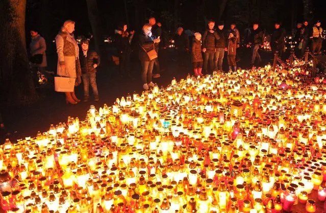 Candles burn on All Saints' Day at the Central Cemetery in Szczecin, Poland, November 1, 2017. People all over Poland visit the graves of beloved ones and leave candles and flowers on them.The cemetery in Szczecin is considered to be the largest necropolis in Poland. (Photo by Marcin Bielecki/EPA/EFE/Rex Features/Shutterstock)