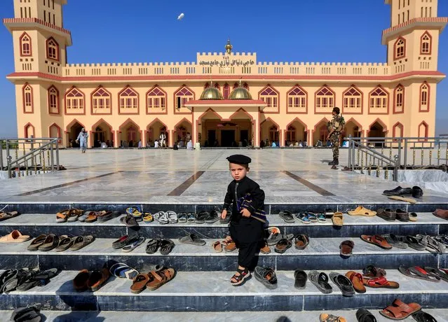 An Afghan boy walks outside a mosque before prayers during Eid al-Fitr, a Muslim festival marking the end the holy fasting month of Ramadan, amid the spread of the coronavirus disease (COVID-19), in Laghman province, Afghanistan on May 24, 2020. (Photo by Parwiz via Reuters)