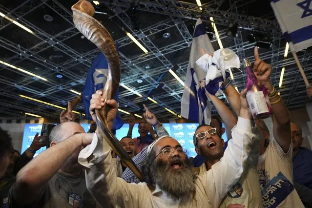 Supporters of Benjamin Netanyahu, former Israeli Prime Minister and the head of Likud party celebrates the first exit poll results for Israel's election, at the Likud party headquarters in Jerusalem, Wednesday, November 2, 2022. (Photo by Tsafrir Abayov/AP Photo)