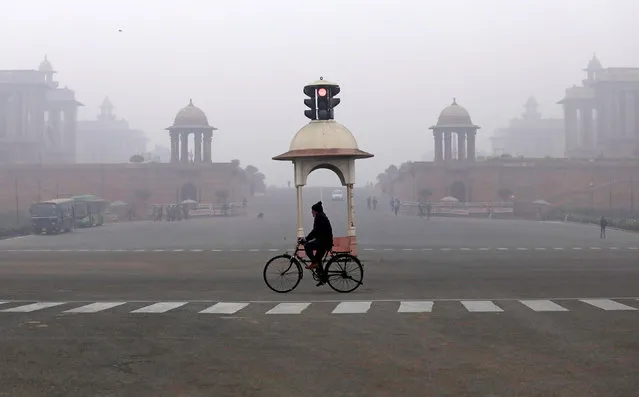 A man cycles across the street on a winter morning in New Delhi, India January 5, 2017. (Photo by Saumya Khandelwal/Reuters)