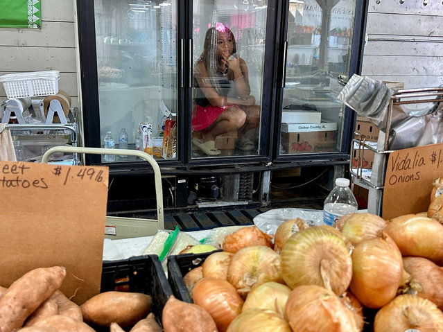 Worker Malian Vue beats the heat inside the refrigerator at the Agricenter Farmers Market in Memphis, Tennessee on July 5, 2025. (Photo by Karen Focht/ZUMA Press Wire/Rex Features/Shutterstock)