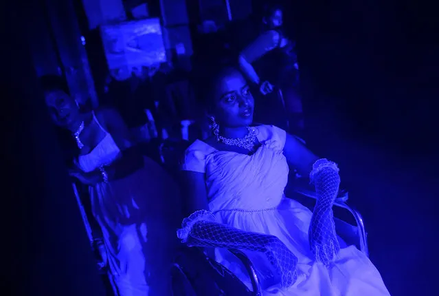 Competitors watch a performance from backstage during the Miss Wheelchair India beauty pageant in Mumbai November 26, 2014. (Photo by Danish Siddiqui/Reuters)