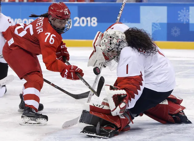 Goalie Shannon Szabados (1), of Canada, deflects a shot by Russian athlete Yekaterina Nikolayeva (76) during the second period of the semifinal round of the women's hockey game at the 2018 Winter Olympics in Gangneung, South Korea, Monday, February 19, 2018. (Photo by Matt Slocum/AP Photo)