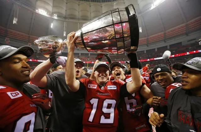 Calgary Stampeders' quarterback Bo Levi Mitchell holds the Grey Cup after the Stampeders defeated the Hamilton Tiger Cats in the CFL's 102nd Grey Cup football championship in Vancouver, British Columbia, November 30, 2014. (Photo by Mark Blinch/Reuters)