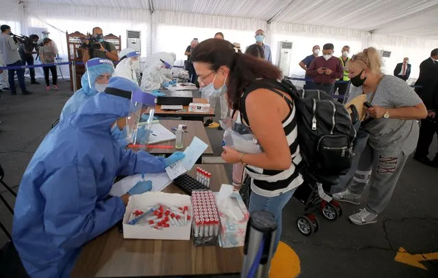 Health workers collect samples for polymerase chain reaction (PCR) tests for arriving tourists at screening center of Sharm el-Sheikh International Airport, Egypt, 24 September 2020. According to reports, all passengers arriving to Egypt airports are required to provide a negative PCR test for coronavirus as of 01 September. However foreign tourists landing at Hurghada, Sharm El-Sheikh, Marsa Alam can undergo the test upon arrival at the airports for 30 US dollars. (Photo by Khaled Elfiqi/EPA/EFE/Rex Features/Shutterstock)