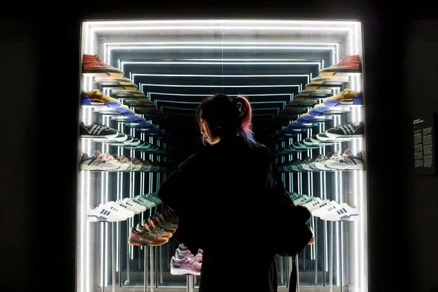 A visitor looks at a display of limited edition sneakers of various brands made in collaboration with local sneaker shop Limited Edt, during the media preview of Sneakertopia, a sneaker and street culture exhibition, at the Art Science Museum in Singapore on February 23, 2023. (Photo by Edgar Su/Reuters)