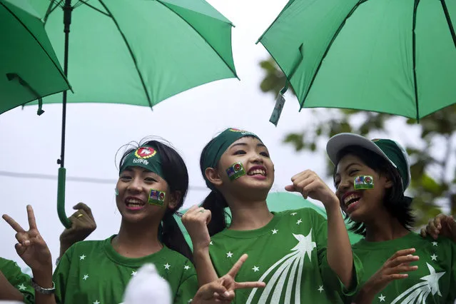 Singers perform on a motorcade during a campaign rally by supporters of the army-backed ruling Union Solidarity and Development Party (USDP) in Yangon on October 30, 2015. The once junta-run nation heads to the polls on November 8 in what voters and observers hope will be the freest election in decades. (Photo by Ye Aung Thu/AFP Photo)