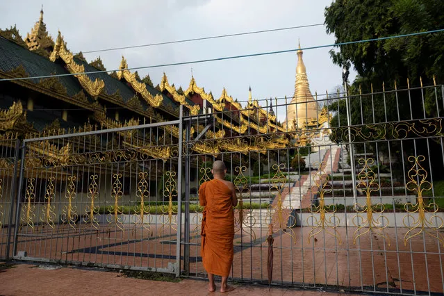 A Buddhist monk prays outside the temporary closed Shwedagon Pagoda amid the outbreak of the coronavirus disease (COVID-19), in Yangon, Myanmar, October 1, 2020. (Photo by Shwe Paw Mya Tin/Reuters)