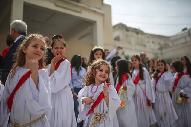 Orthodox Christians attend the Palm Sunday procession in Gaza City, Gaza on April 01, 2018. Palm Sunday is celebrated on last Sunday before the “Easter” for triumphal entry of Jesus Christ into Jerusalem and memory of palm branches were placed in his path. (Photo by Mustafa Hassona/Anadolu Agency/Getty Images)