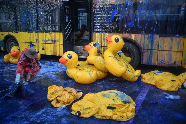 Pro-democracy protesters holding a duck doll after police fire tear gas during a demonstration against a charter amendment at Parliament in Bangkok, Thailand on November 17, 2020. (Photo by Vichan Poti/Pacific Press/Rex Features/Shutterstock)