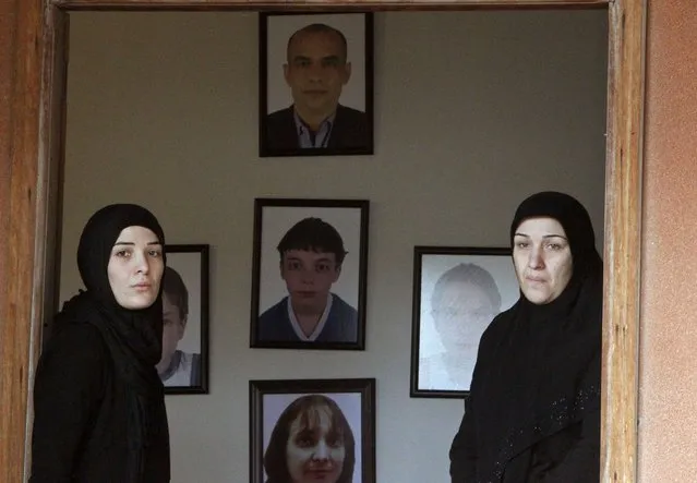 Relatives stand in front of pictures of Lebanese passenger Bilal al-Dehaini, his wife and his three children, who were among the Lebanese victims of Air Algerie flight AH5017, during their funeral in al-Kharayeb village, southern Lebanon December 22, 2014. The Air Algerie flight crashed in July en route from Ouagadougou in Burkina Faso to Algiers with 110 passengers on board, an Algerian aviation official said. (Photo by Ali Hashisho/Reuters)