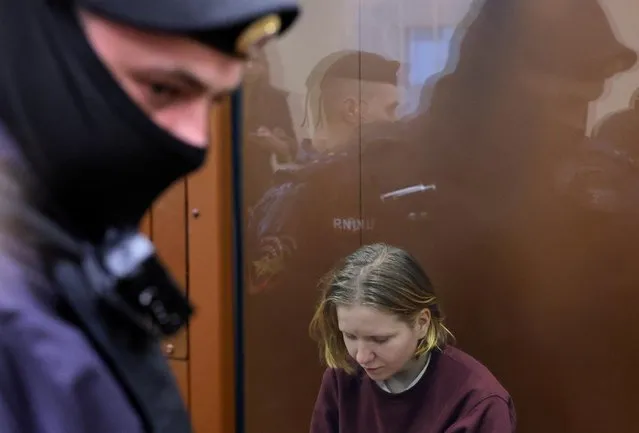 Darya Trepova, who is suspected of the killing of Russian military blogger Maxim Fomin widely known by the name of Vladlen Tatarsky, sits behind a glass wall of an enclosure for defendants during a court hearing in Moscow, Russia on April 4, 2023. (Photo by Evgenia Novozhenina/Reuters)