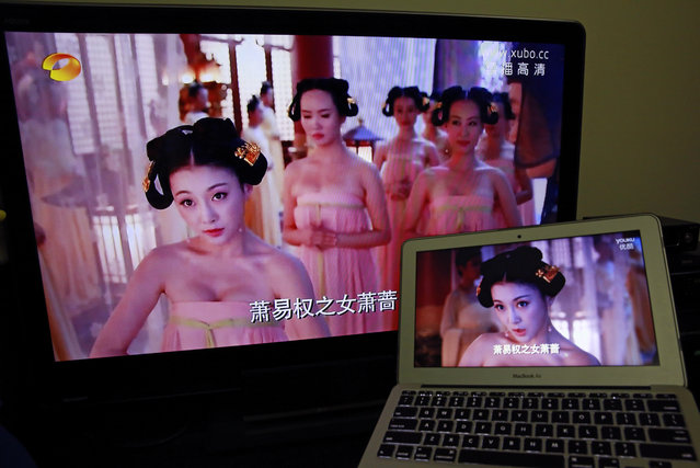 In this Thursday,  January 8, 2015 photo, a television, left, displays the original version of a popular drama next to a computer displaying the version that was re-edited in Beijing, China. At the end of December, a popular television series chronicling China's most famous empress suddenly went on four-day hiatus. When it returned on New Year's Day, the low-cut necklines and squeezed bosoms had vanished. (Photo by Andy Wong/AP Photo)