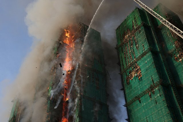 Smoke rises as flames engulf bamboo scaffolding across multiple buildings at Wang Fuk Court housing estate, in Tai Po, Hong Kong, China, on November 26, 2025. (Photo by Tyrone Siu/Reuters)