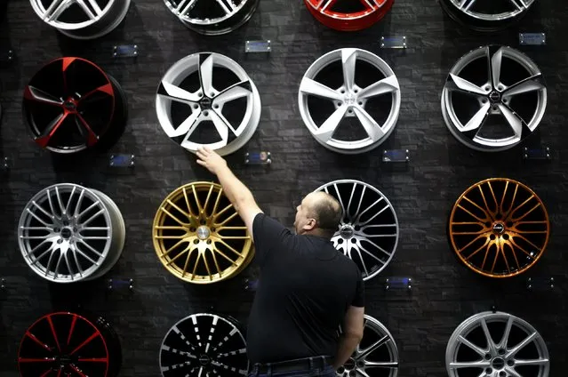 A visitor looks at car rims at the Essen Motor Show in Essen, Germany, November 27, 2015. (Photo by Ina Fassbender/Reuters)