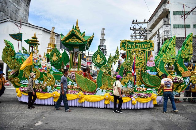 Buddhist devotees walk with a float during a parade celebrating the end of the Buddhist Lent in Thailand's southern province of Narathiwat on October 8, 2025. (Photo by Madaree Tohlala/AFP Photo)