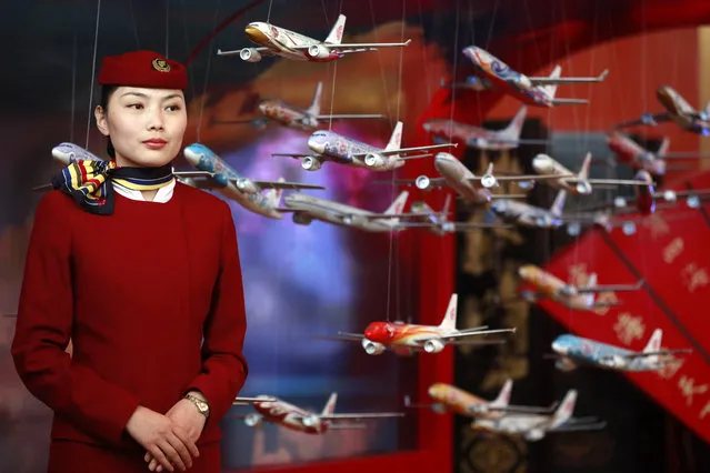 In this June 12, 2012, file photo, an Air China flight attendant stands near model planes at the International Air Transport Association (IATA) 68th Annual General Meeting (AGM) and World Air Transport Summit in Beijing. Global airlines are obeying Beijing's demands to refer to Taiwan explicitly as a part of China, despite the White House's call this month to stand firm against such “Orwellian nonsense”. (Photo by Ng Han Guan/AP Photo)
