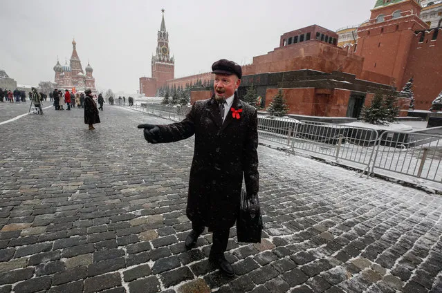 An impersonator of Vladimir Lenin, a founder of the Russian Communist party and father of the Communist revolution, walks in front of Lenin's mausoleum during a commemoration for his 97th death anniversary on the Red Square in Moscow, Russia, 21 January 2021. Lenin, who died in 1924, was placed in the mausoleum despite his wish to be buried near his mother at Volkovo cemetery in St. Petersburg. (Photo by Sergei Ilnitsky/EPA/EFE)