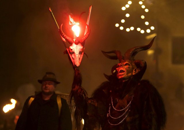 A man dressed as a devil performs during a Krampus show in the southern Bohemian town of Kaplice, December 12, 2015. (Photo by David W. Cerny/Reuters)