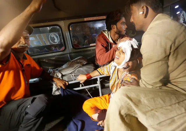 A woman sits in an ambulance as she arrives by ambulance after an explosion in at the Shah Noorani Shrine in Baluchistan, at a hospital in Karachi, Pakistan, November 12, 2016. (Photo by Akhtar Soomro/Reuters)