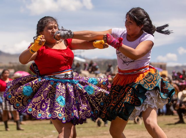 Women dressed in typical costumes face each other at the annual Takanakuy festival, which means to “hit each other” in Quechua, and is celebrated to resolve conflicts and strengthen relationships, in Llique, Chumbivilcas province, Peru on December 26, 2024. (Photo by Oswald Charca/Reuters)