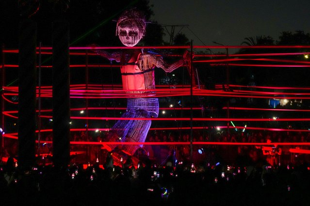 Mo, a giant puppet representing a boy who leaves his home war-torn country as part of the Mo and the Ribbon spectacle, walks past people at Santiago a Mil Theater Festival in Santiago, Chile, Wednesday, January 15, 2025. (Photo by Esteban Felix/AP Photo)